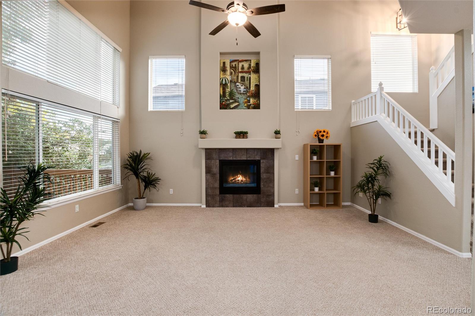 9218 Fox Fire Lane Highlands Ranch, CO 80129 - Photo 17 of 38 a view of an empty room with a fireplace and a window