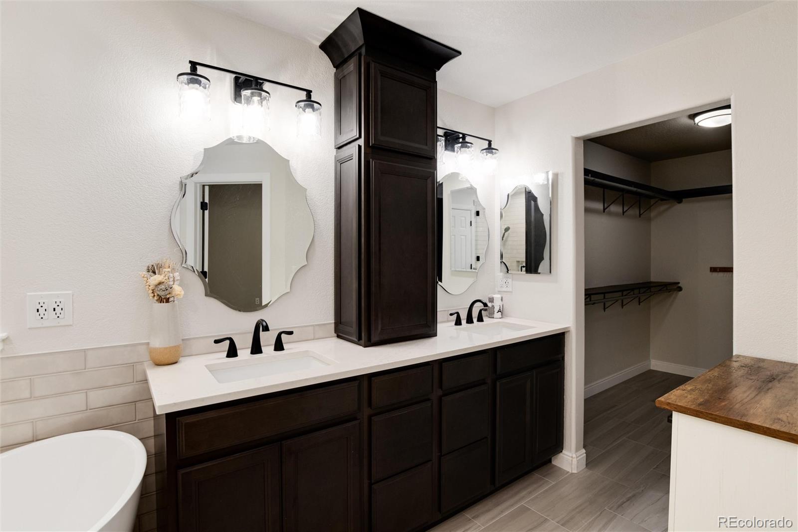 9218 Fox Fire Lane Highlands Ranch, CO 80129 - Photo 26 of 38 a bathroom with a double vanity sink and mirror