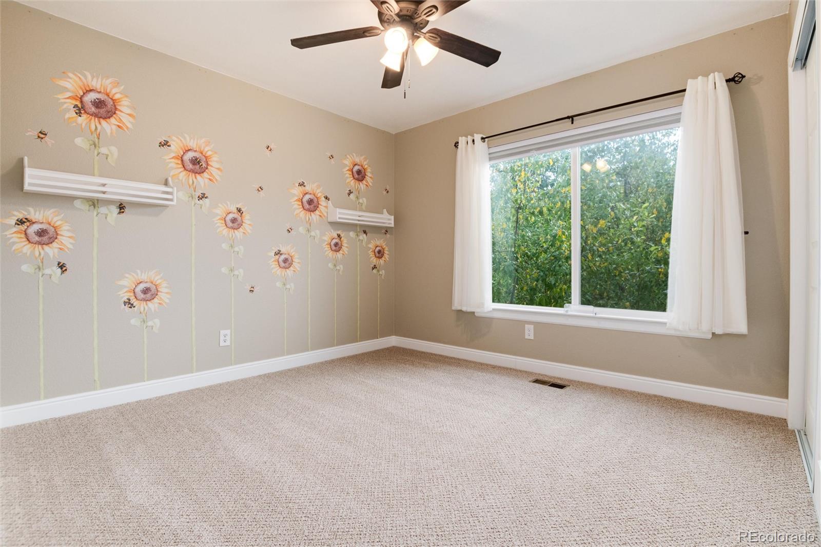 9218 Fox Fire Lane Highlands Ranch, CO 80129 - Photo 28 of 38 an empty room with windows and fan