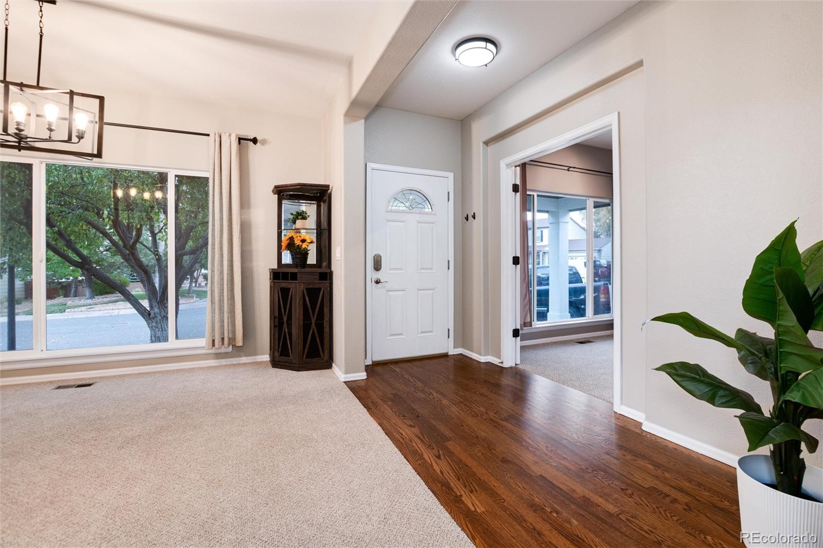 9218 Fox Fire Lane Highlands Ranch, CO 80129 - Photo 3 of 38 a view of a room with wooden floor and windows