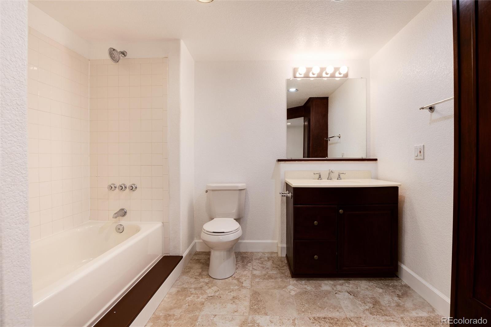 9218 Fox Fire Lane Highlands Ranch, CO 80129 - Photo 32 of 38 a bathroom with a sink a toilet and bathtub