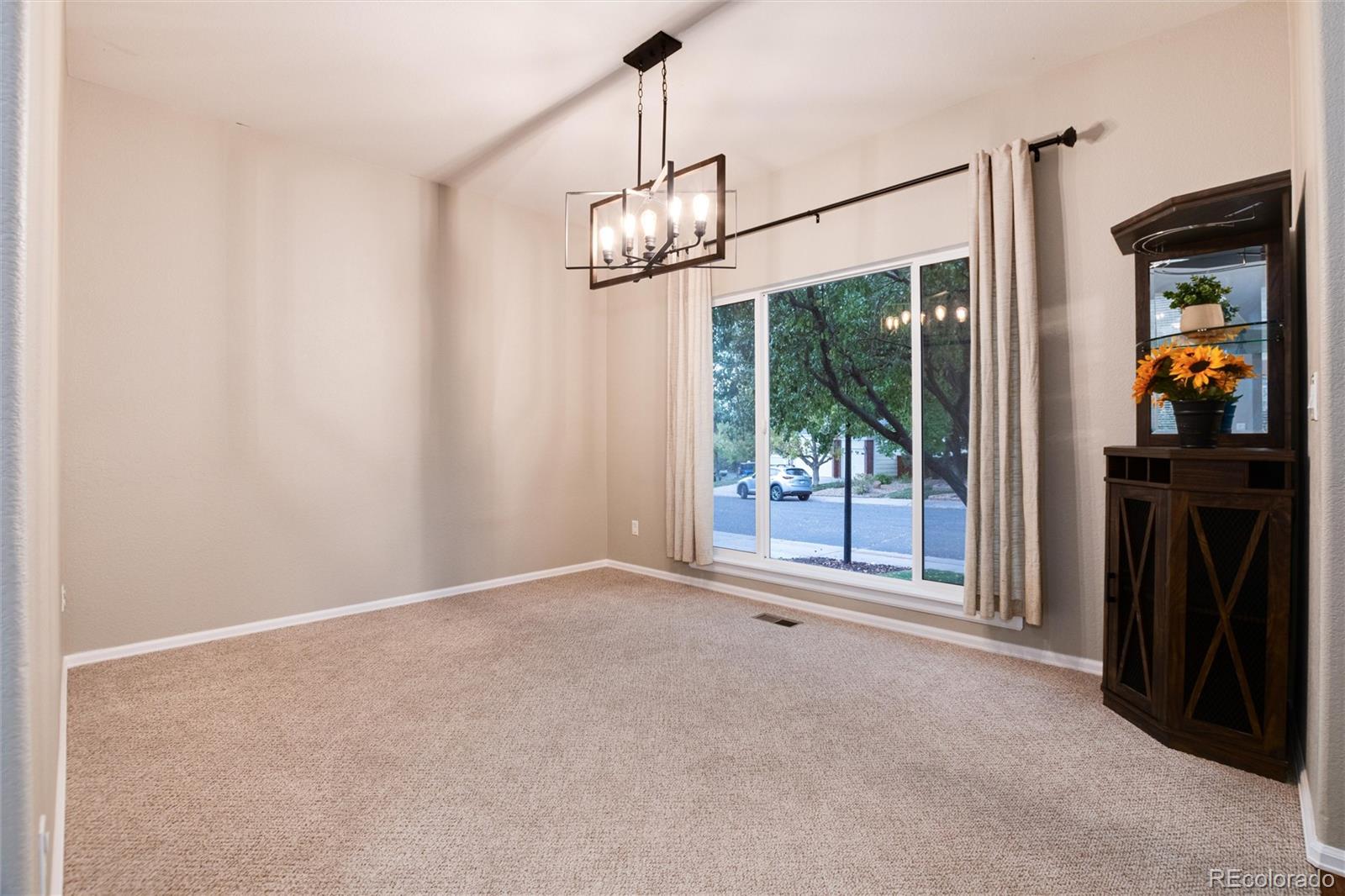 9218 Fox Fire Lane Highlands Ranch, CO 80129 - Photo 4 of 38 a view of empty room with wooden floor and windows
