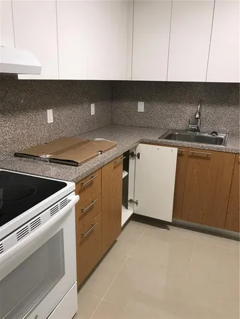 a kitchen with a sink and a stove