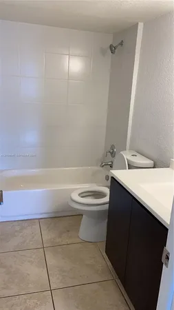 a bathroom with a sink a toilet and bathtub