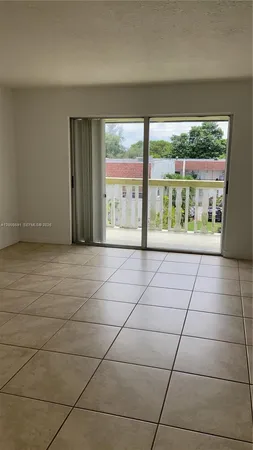 a view of an empty room with a floor to ceiling window
