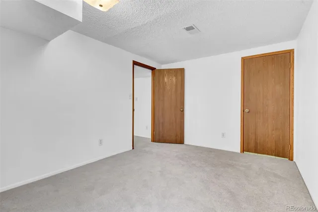 a view of an empty room and closet area