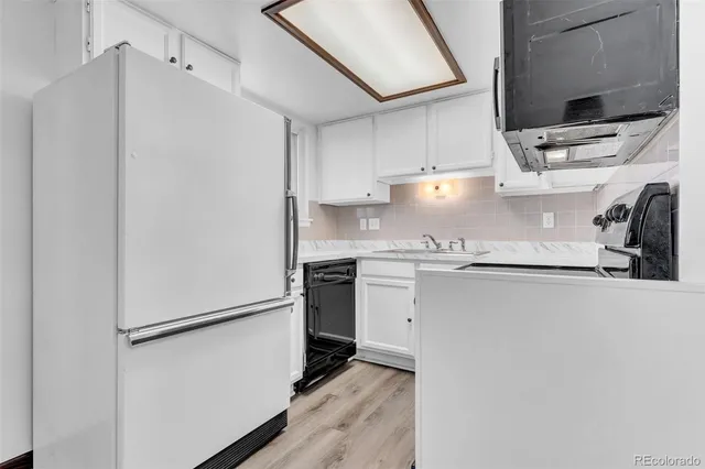a kitchen with stainless steel appliances a refrigerator sink and cabinets