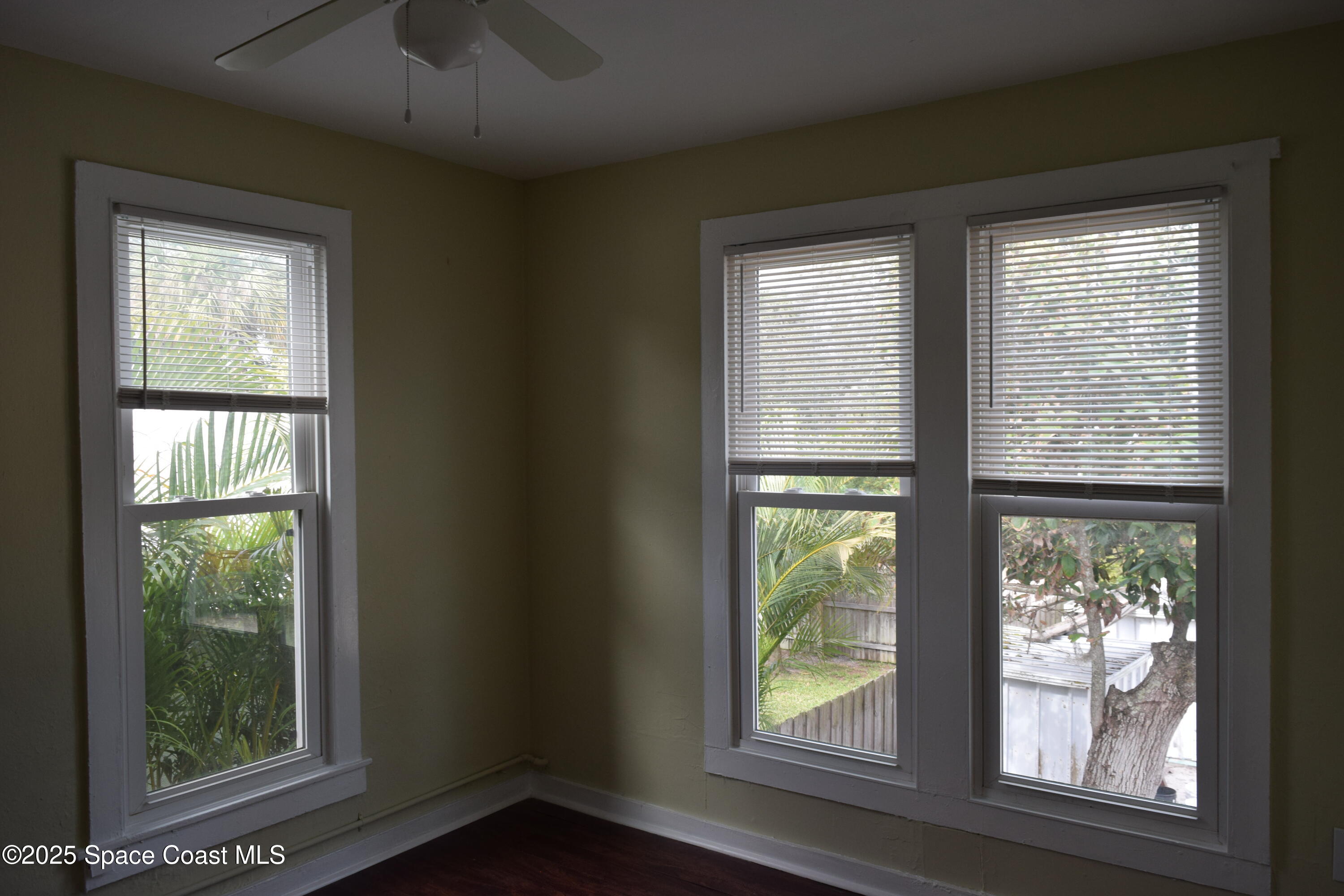 658 Young Street, Unit 2 Melbourne, FL 32935 - Photo 11 of 15 a view of an empty room with wooden floor and a window