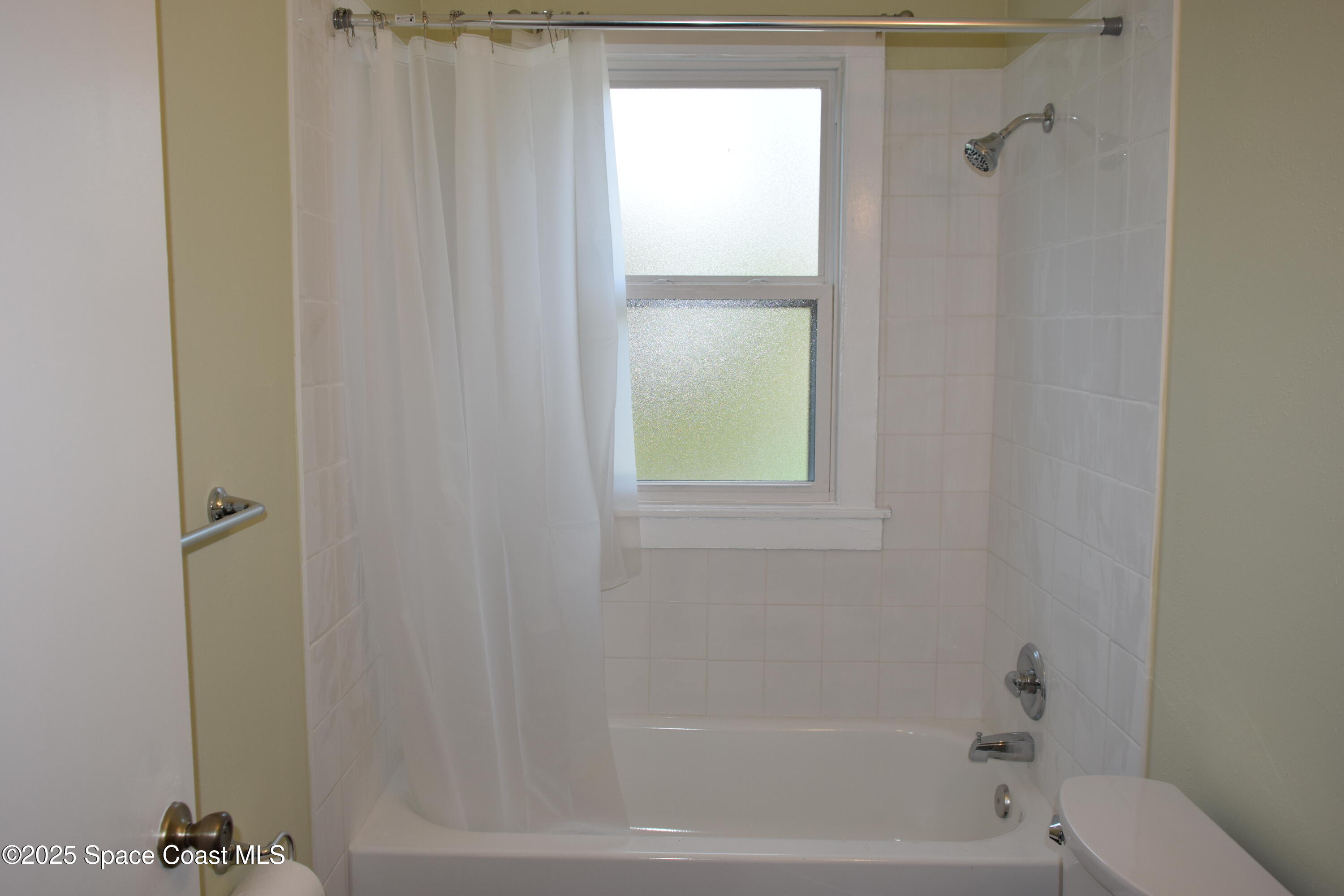 658 Young Street, Unit 2 Melbourne, FL 32935 - Photo 14 of 15 a close up of a bathtub curtain