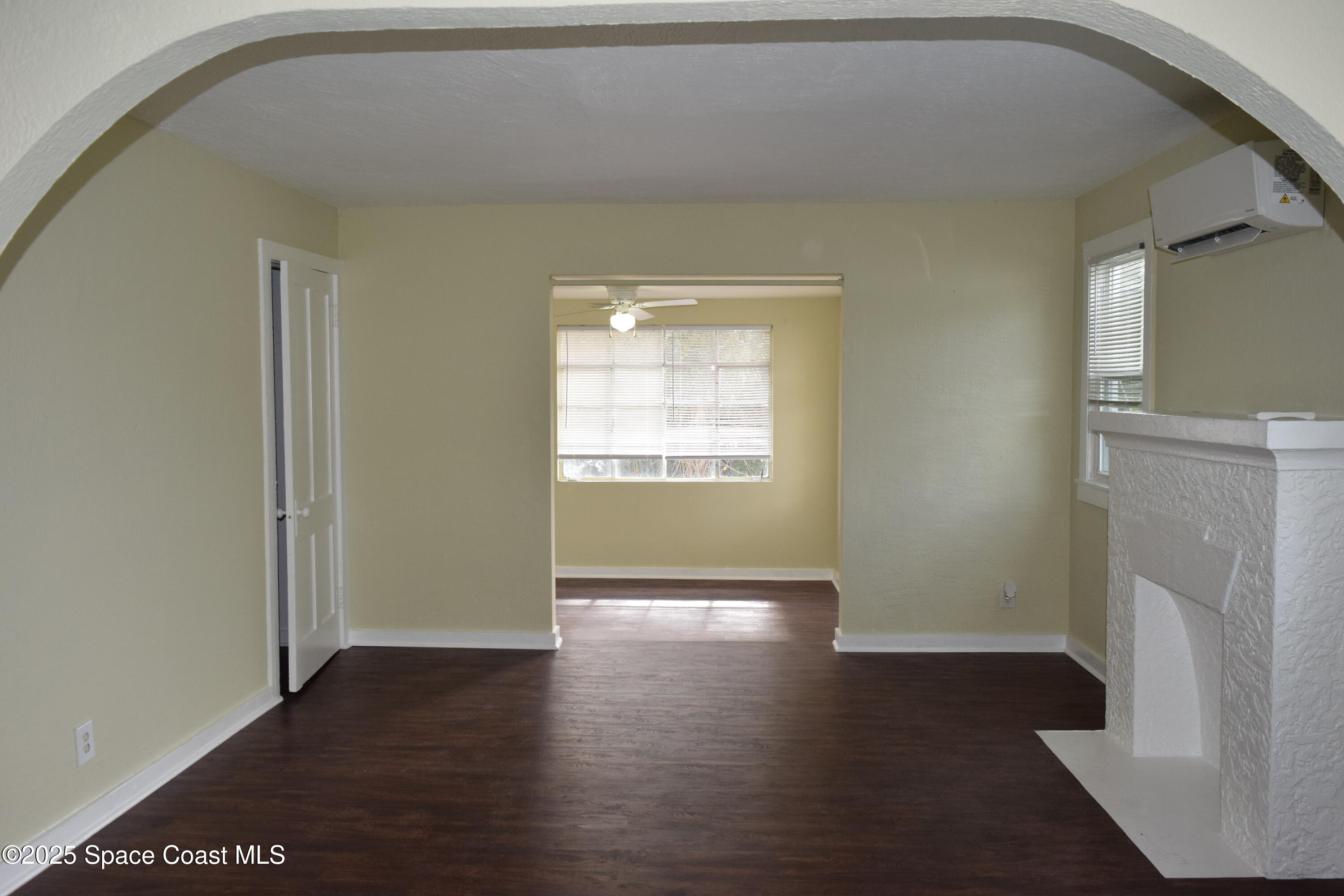658 Young Street, Unit 2 Melbourne, FL 32935 - Photo 3 of 15 an empty room with wooden floor and a window