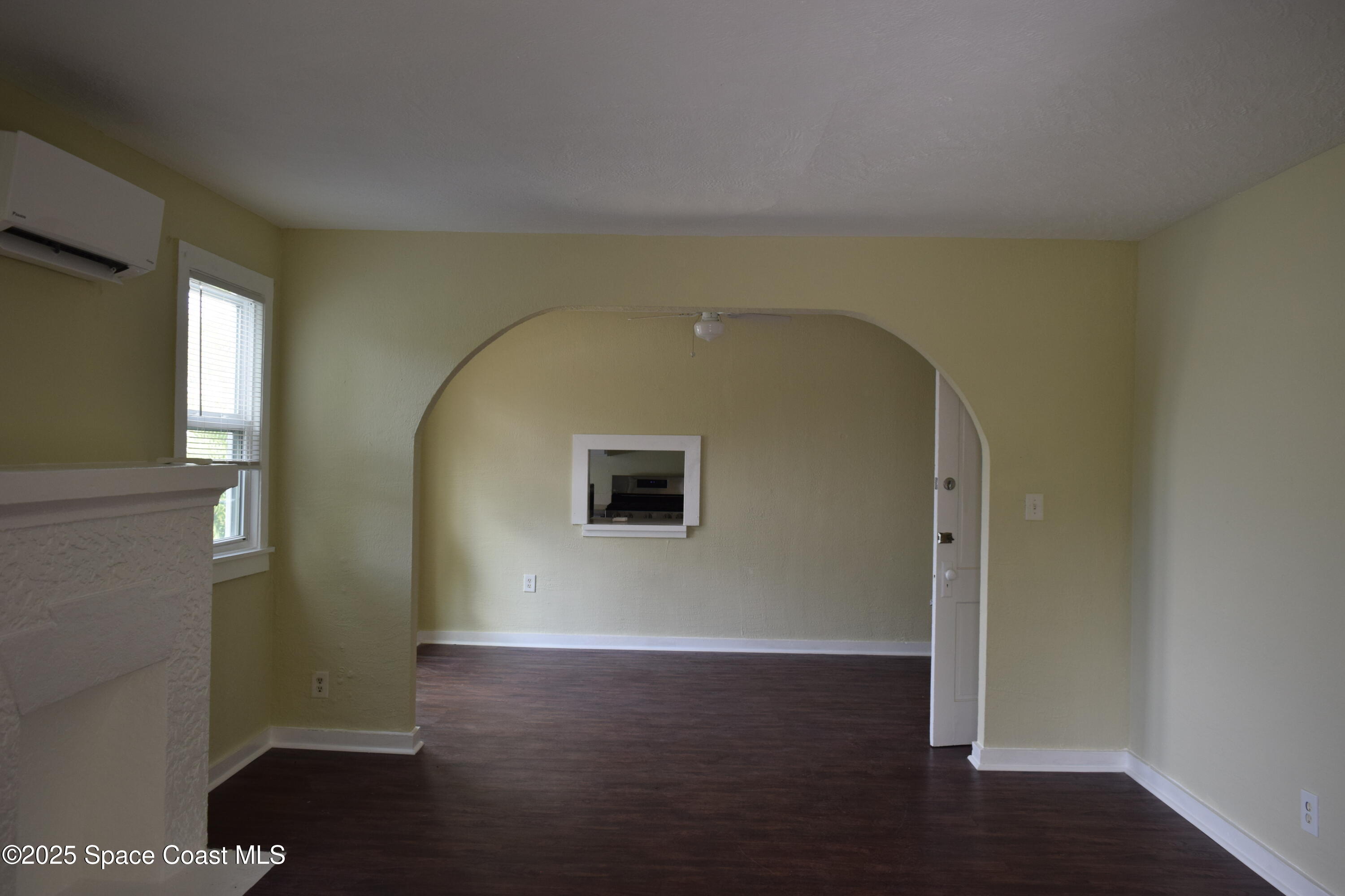 658 Young Street, Unit 2 Melbourne, FL 32935 - Photo 4 of 15 an empty room with wooden floor and windows