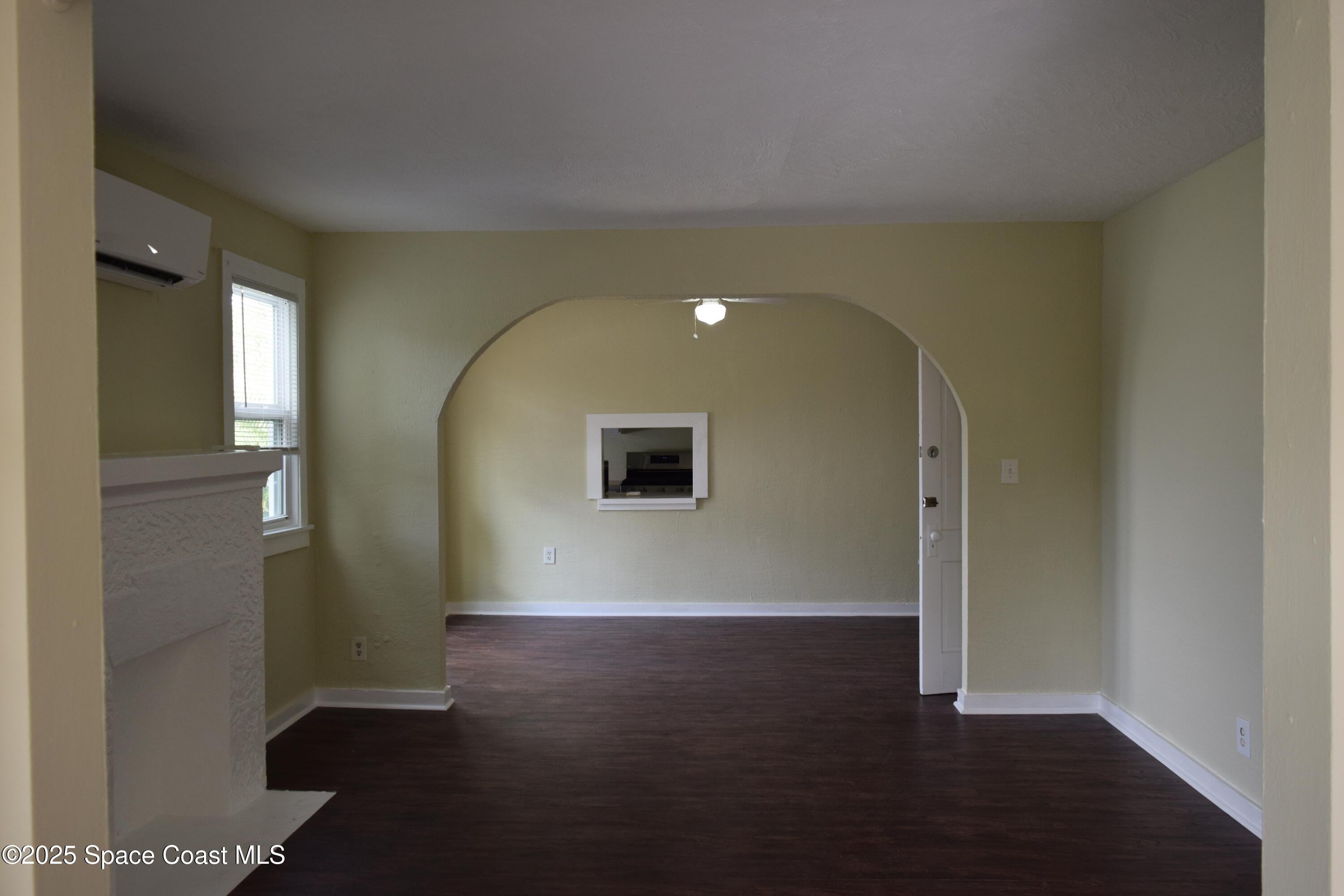 658 Young Street, Unit 2 Melbourne, FL 32935 - Photo 6 of 15 an empty room with wooden floor and windows