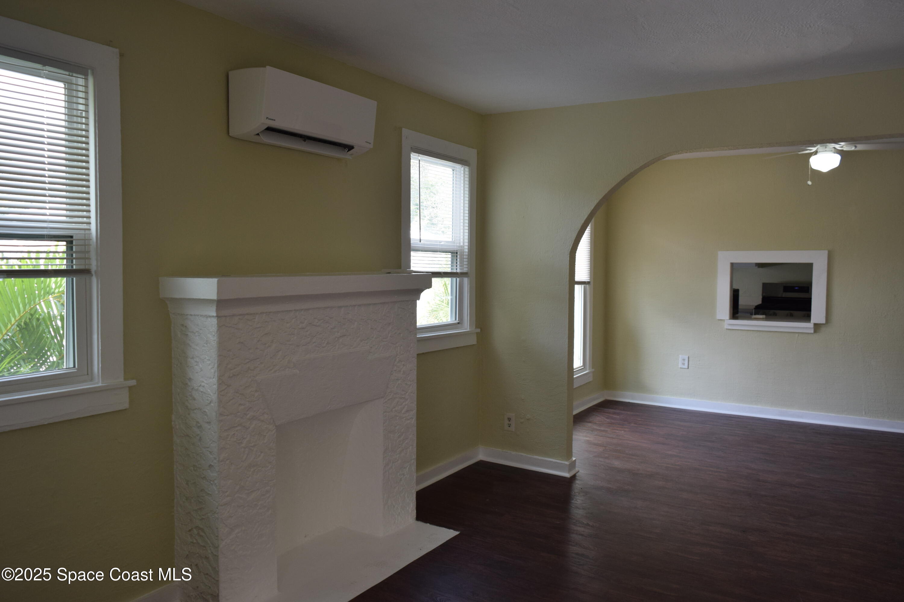 658 Young Street, Unit 2 Melbourne, FL 32935 - Photo 7 of 15 an empty room with wooden floor and windows