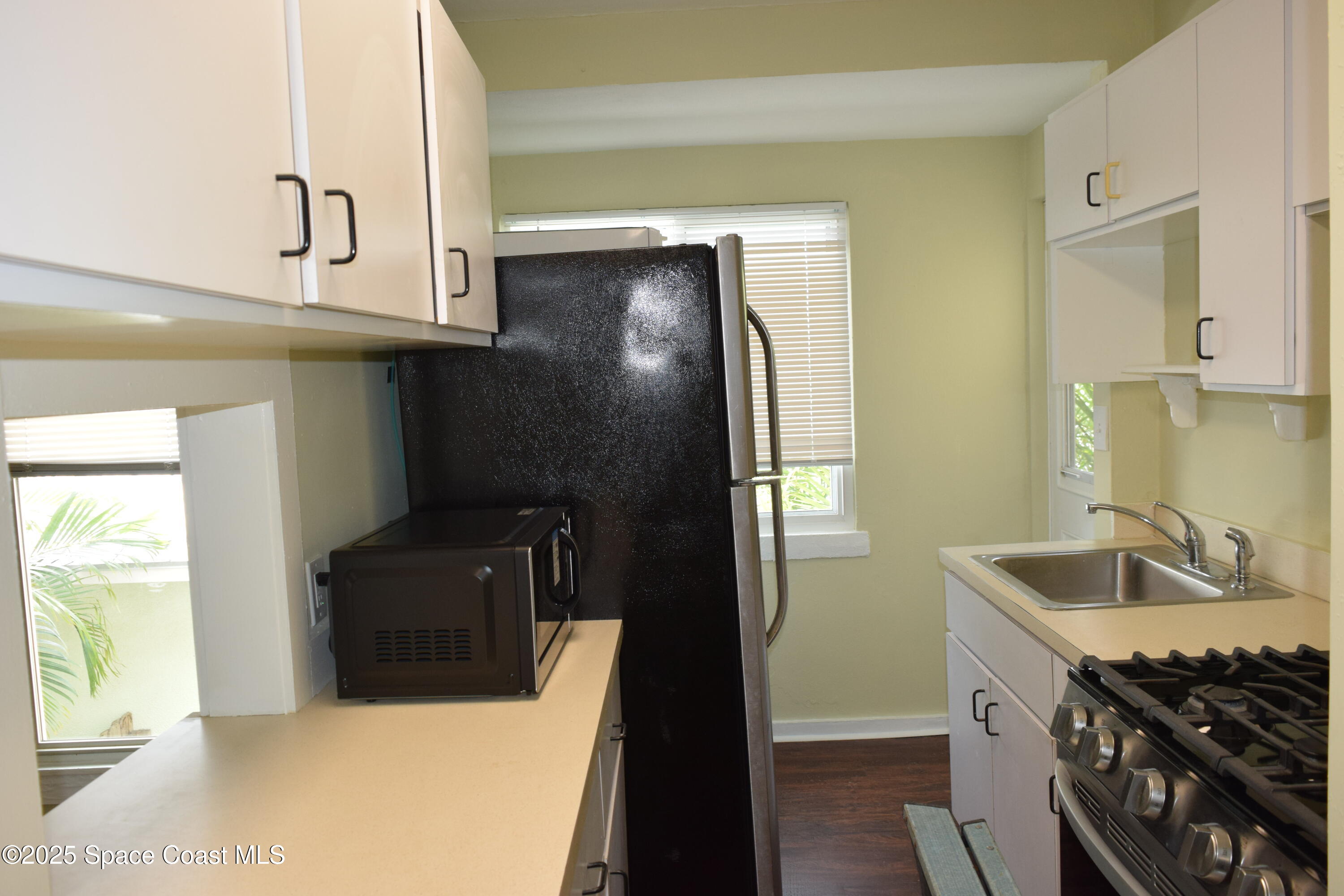 658 Young Street, Unit 2 Melbourne, FL 32935 - Photo 8 of 15 a bathroom with a sink and a mirror