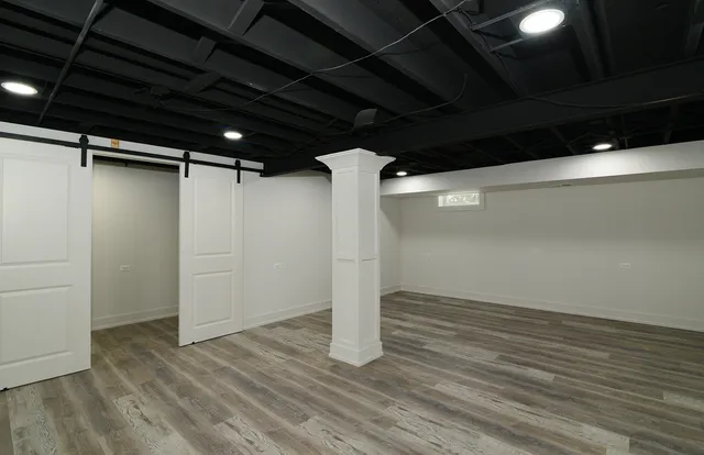 a view of a hallway with wooden floor and staircase