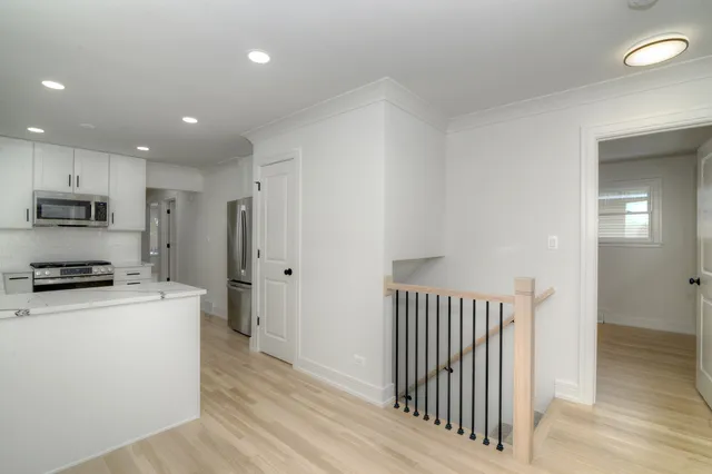 a kitchen with stainless steel appliances a refrigerator and a stove top oven