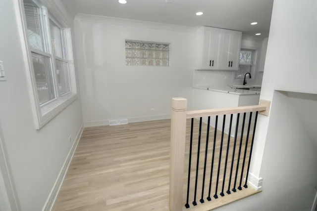 a view of a kitchen with wooden floor and staircase