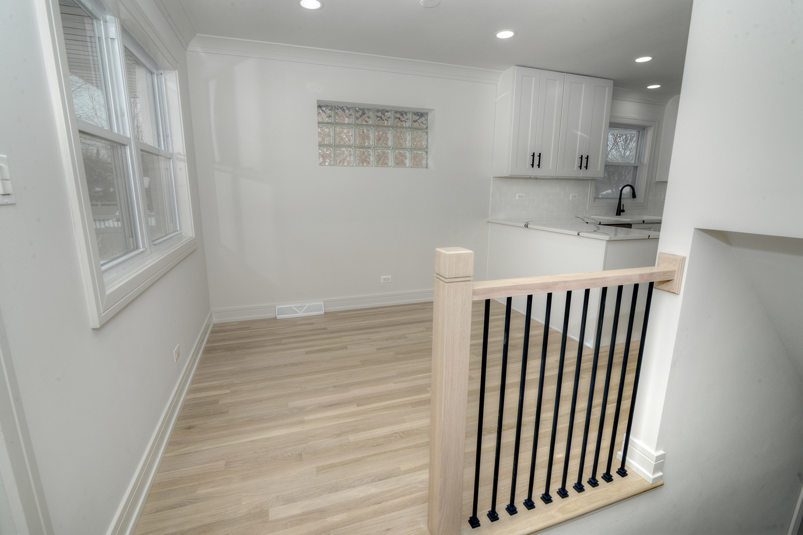 324 Parkside Avenue Itasca, IL 60143 - Photo 9 of 38 a view of a kitchen with wooden floor and staircase