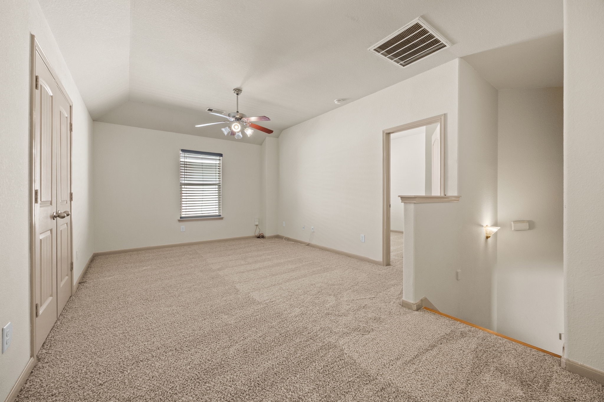 3606 Canvasback Lane Houston, TX 77047 - Photo 19 of 29 Expansive upstairs game room with plush carpet, vaulted ceilings, and endless possibilities for a media room, playroom, home office, or second living area.