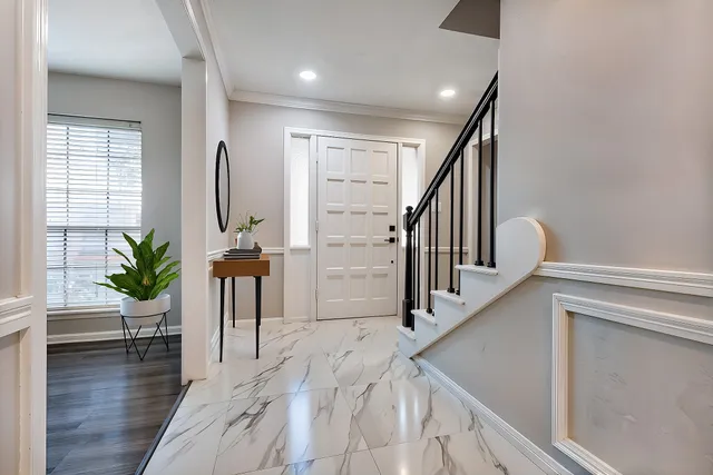 a view of entryway and hall with wooden floor