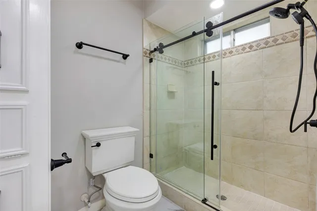 a white toilet sitting next to a bathroom