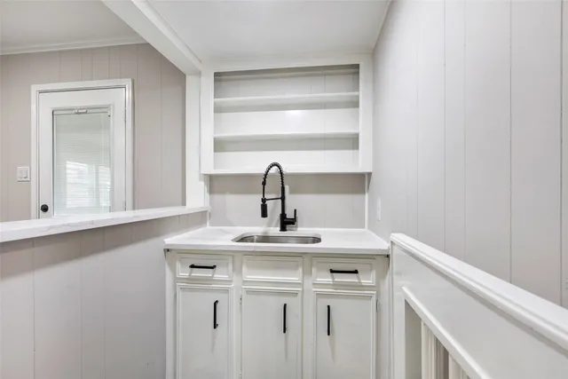 a kitchen with a sink and cabinets