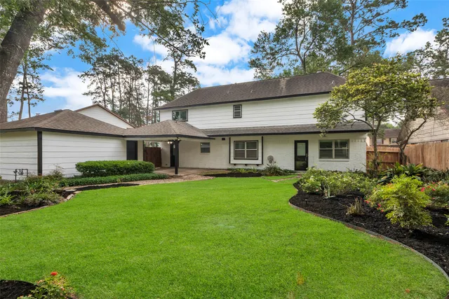 a front view of a house with a garden and porch