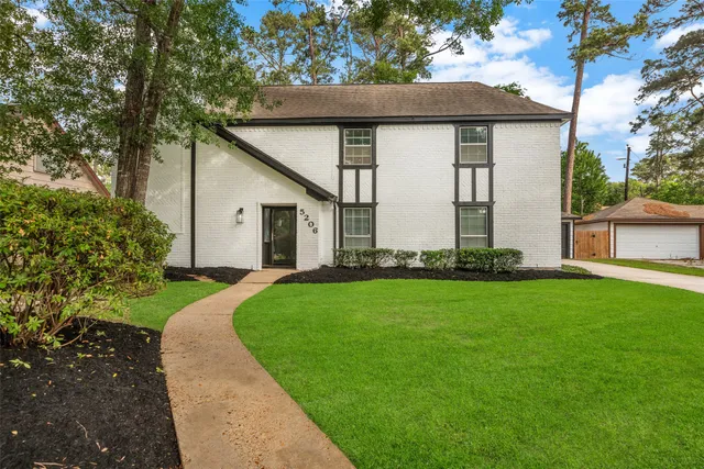 a front view of house with yard and green space