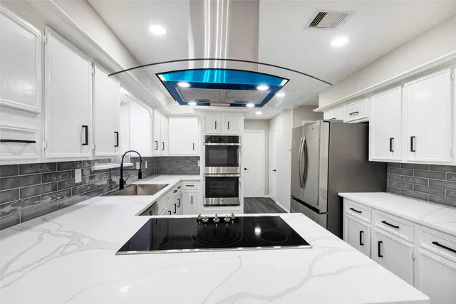 a kitchen with stainless steel appliances a refrigerator sink and cabinets