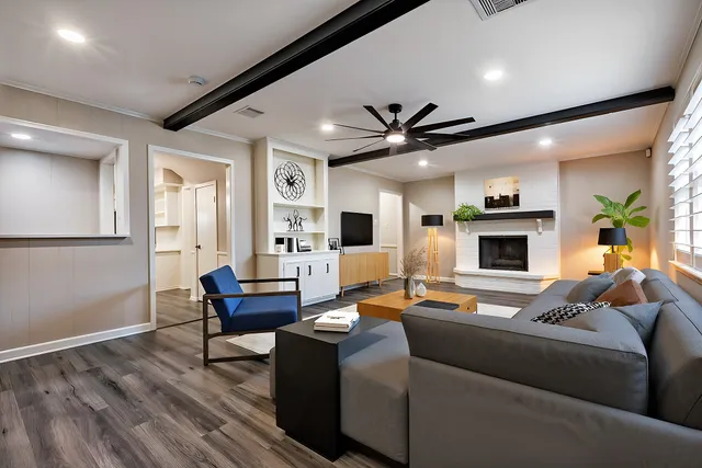 a living room with furniture wooden floor and a fireplace