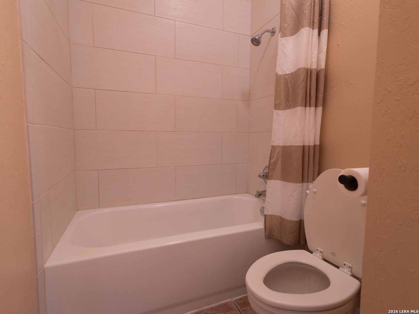 1013 Chestnut Street, Unit C4 San Marcos, TX 78666 - Photo 15 of 22 a white toilet and tub sitting next to a bathroom sink