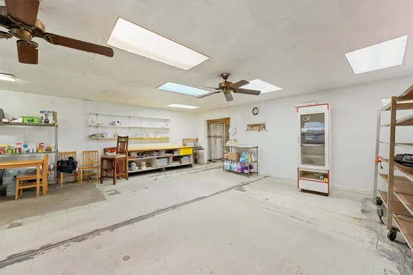 a view of a livingroom with furniture and a kitchen