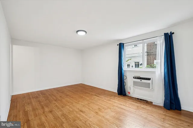 a view of empty room with kitchen and sink