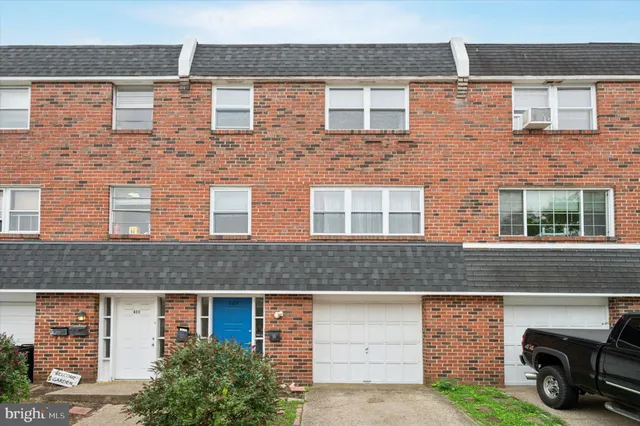 a front view of a house with parking space
