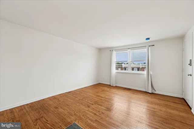 a view of a kitchen with wooden floor and a sink