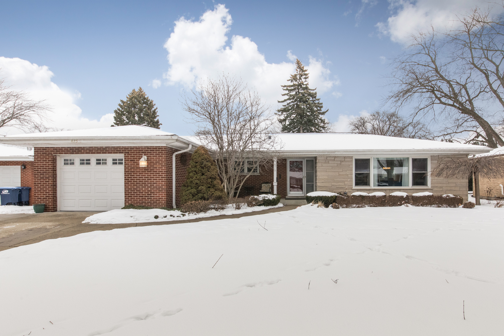 a front view of house with yard outdoor seating and garage