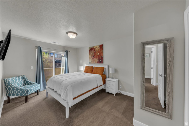 4796 Winged Foot Drive St. George, UT 84770 - Photo 27 of 33 Carpeted bedroom featuring a textured ceiling and access to outside