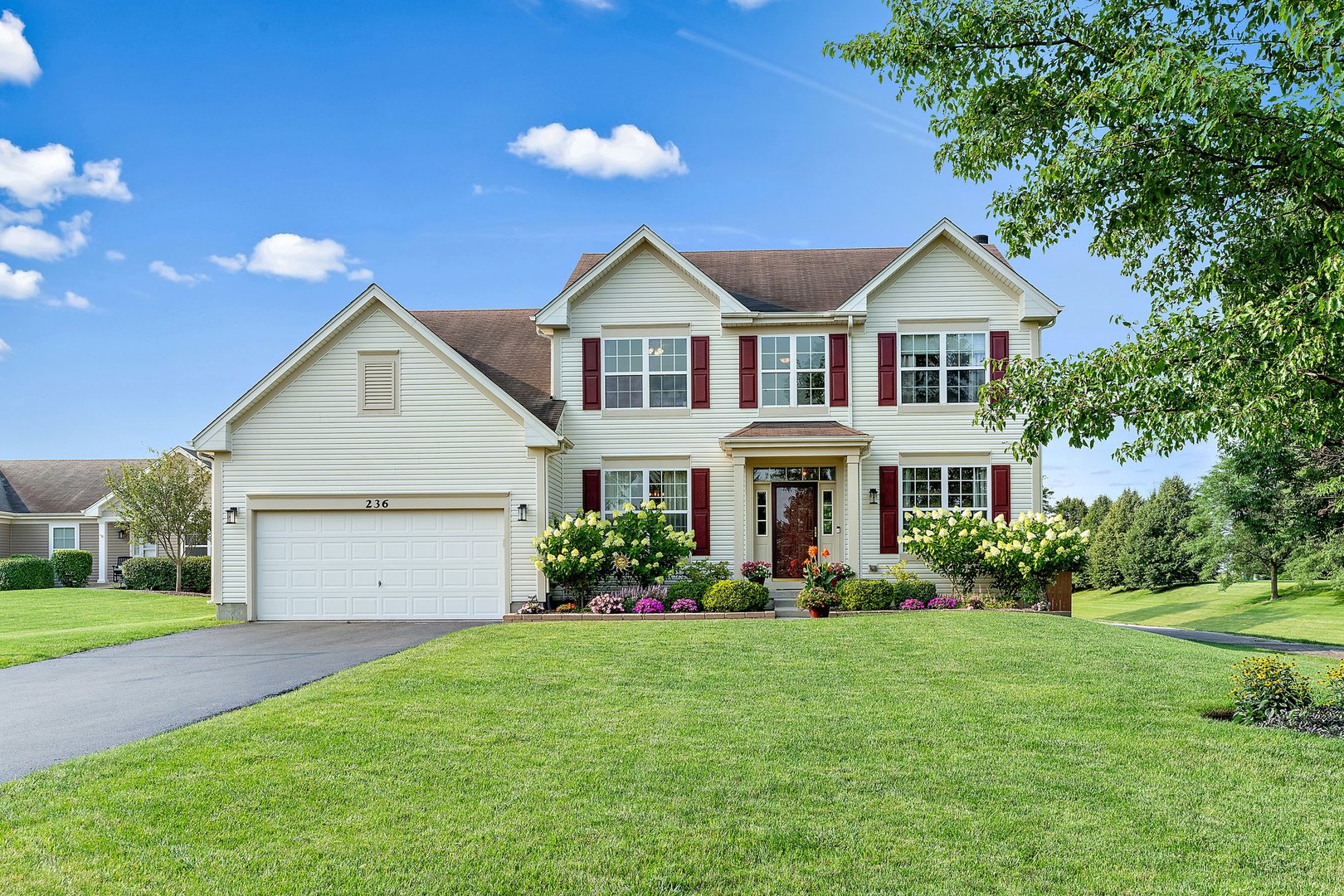 a front view of house with yard and green space