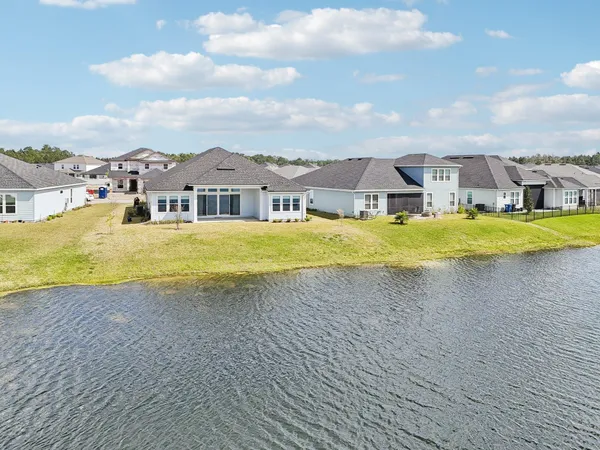 an aerial view of a house with swimming pool and ocean view