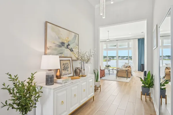 a living room with furniture flat screen tv and a large window