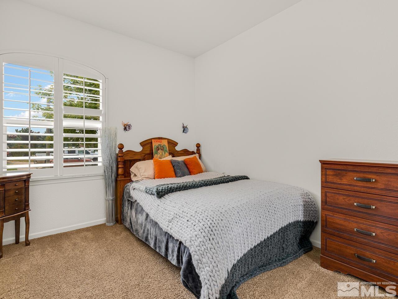 10550 Apple Mill Court Reno, NV 89521 - Photo 17 of 27 a bedroom with a bed and a window