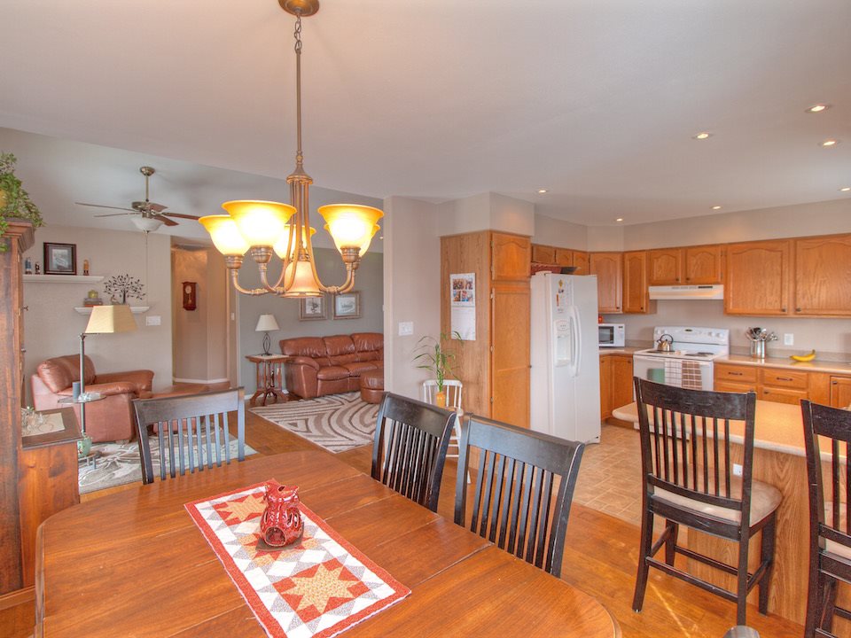 2949 Erika Road Grand Junction, CO 81504 - Photo 4 of 20 a dining room with furniture a chandelier and wooden floor