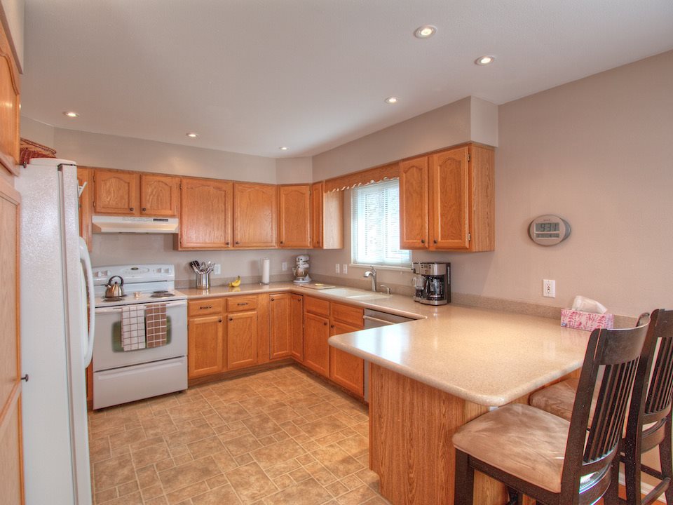 2949 Erika Road Grand Junction, CO 81504 - Photo 5 of 20 a kitchen with a stove a sink a dining table and chairs