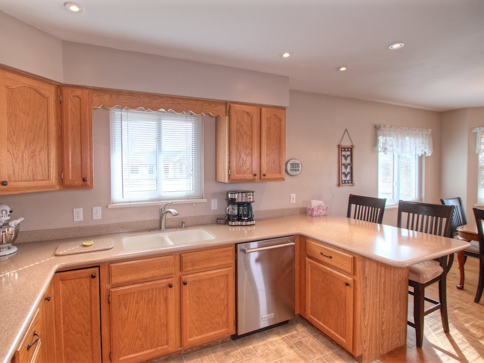 2949 Erika Road Grand Junction, CO 81504 - Photo 6 of 20 a kitchen with granite countertop a sink cabinets and window