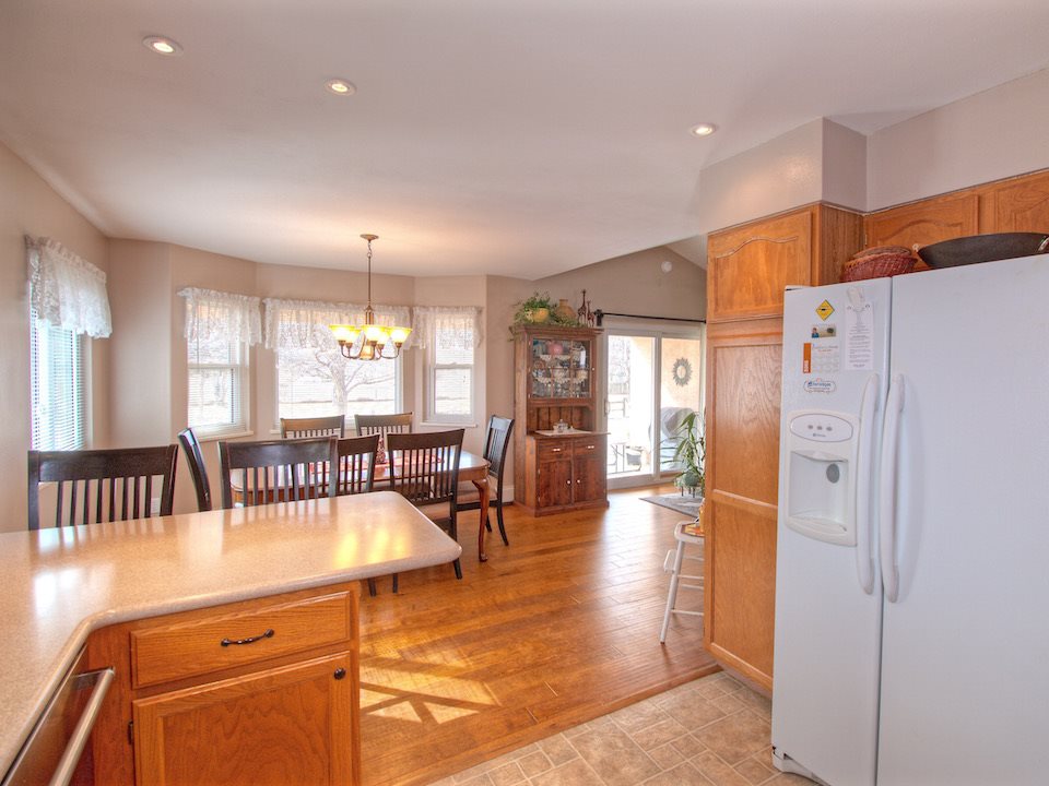 2949 Erika Road Grand Junction, CO 81504 - Photo 7 of 20 an open kitchen with dining table and refrigerator