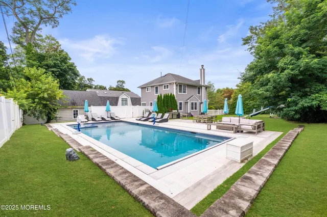 a view of a house with swimming pool and a yard