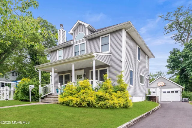 a front view of a house with a garden and plants