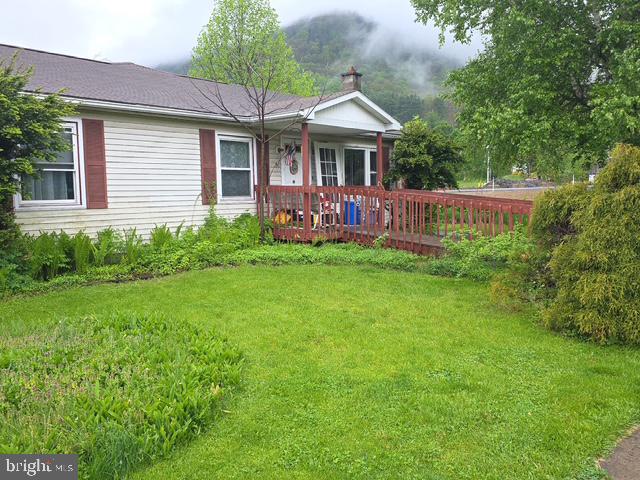 100 Mill Street Trout Run, PA 17771 - Photo 1 of 17 a view of a house with a backyard and a patio