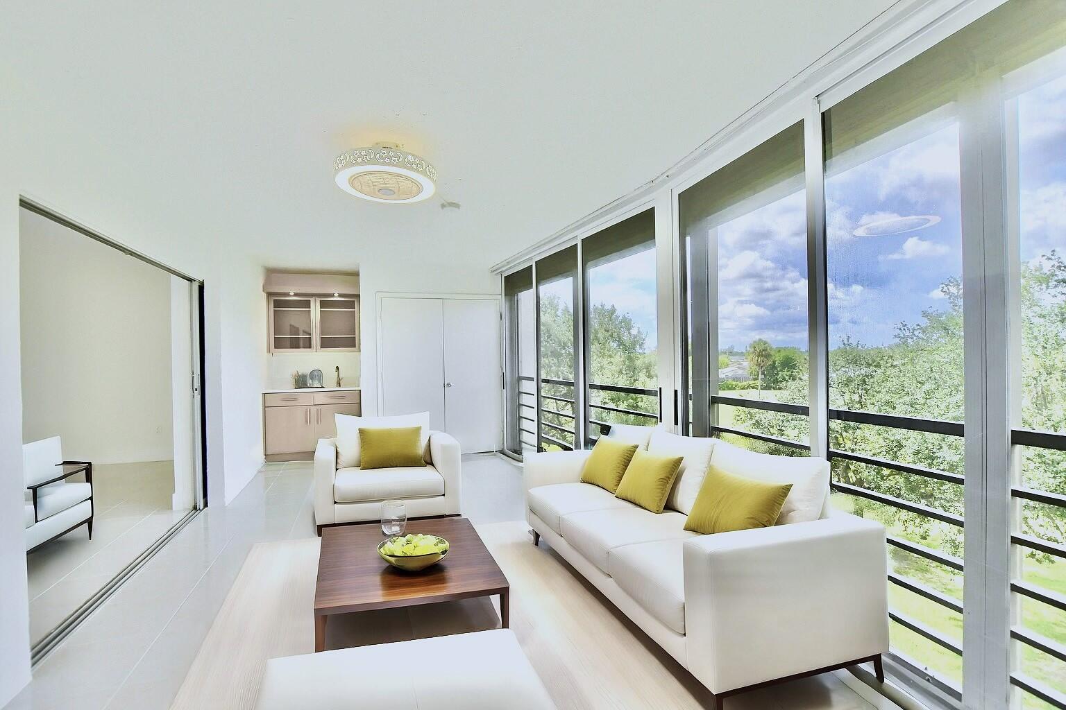 9170 Southwest 14th Street, Unit 4405 Boca Raton, FL 33428 - Photo 6 of 48 a living room with furniture and a large window