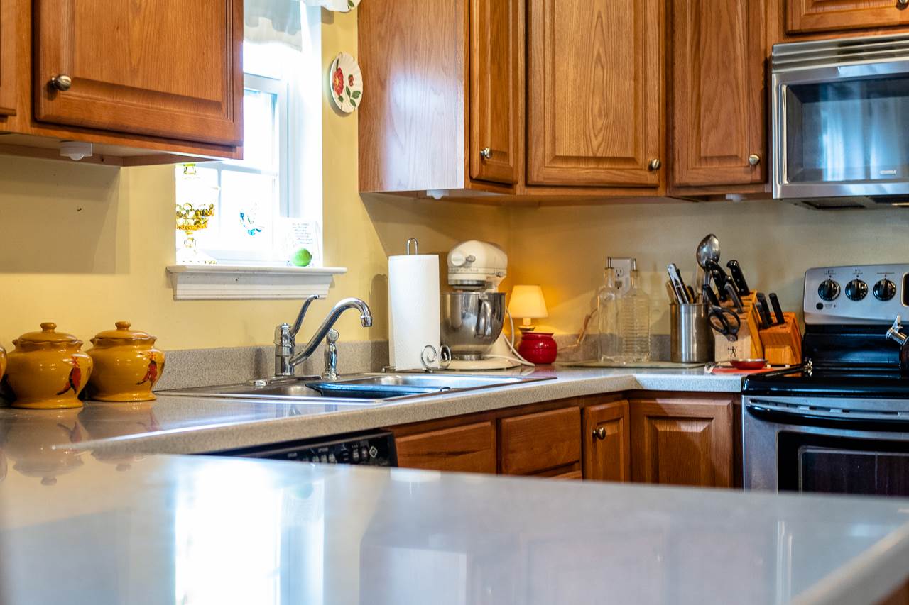 128 Gentry Road Weyers Cave, VA 24486 - Photo 12 of 48 a kitchen with stainless steel appliances granite countertop a sink a stove and a microwave
